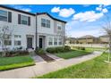 Inviting townhouse exterior with well-maintained lawn and modern architectural details at 3270 Water Sprite St, Orlando, FL 32808