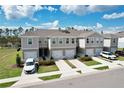 Charming townhomes featuring neutral exteriors, attached garages, and well-maintained landscaping at 421 Sedgewick Dr, Davenport, FL 33837