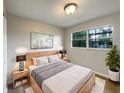 Cozy bedroom with a comfortable bed, side tables, and a window at 4561 Evers Pl, Orlando, FL 32811