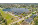 Aerial view of a lakeside community showcasing a beautiful lake and well-manicured lawns at 524 Quail View Ct, Debary, FL 32713