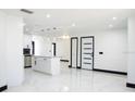 Bright, open kitchen with an island, pendant lighting, and stainless steel appliances with polished marble floors at 5443 Aeolus Way, Orlando, FL 32808