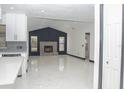 Open-concept living area featuring a sleek fireplace, lots of light, and polished marble floors at 5443 Aeolus Way, Orlando, FL 32808