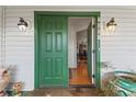 Green front door revealing hardwood floors and an open floor plan at 7025 Big Bend Dr, St Cloud, FL 34771