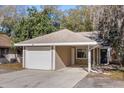 Inviting home exterior with a single car garage and covered entry at 703 Linden Dr, Winter Springs, FL 32708