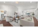 Spacious living room with vaulted ceilings, hardwood floors and neutral décor overlooking dining area at 703 Linden Dr, Winter Springs, FL 32708