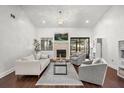 Bright living room features vaulted ceiling, fireplace, and sliding glass doors to the outside at 703 Linden Dr, Winter Springs, FL 32708