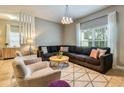 Comfortable living room boasts a large sectional sofa and abundant natural light at 8962 Sugar Palm Rd, Kissimmee, FL 34747