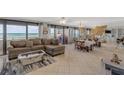 Open living room with ocean views, tile flooring, and a modern sectional sofa at 901 S Atlantic Ave # 208, Ormond Beach, FL 32176