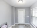 Bright entryway features tile floors, a window with blinds, and a door with glass at 10566 Green Ivy Ln, Orlando, FL 32832