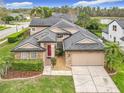 Aerial view of a well-maintained home with a landscaped yard and picturesque neighborhood setting at 1609 River Birch Ave, Oviedo, FL 32765