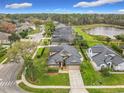 Aerial view of home in a residential neighborhood with nearby lake at 1609 River Birch Ave, Oviedo, FL 32765