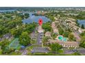 Aerial view of community with lake access, a pool, and lush landscaping at 200 Maitland Ave # 12, Altamonte Springs, FL 32701