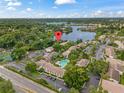 Community aerial view featuring a sparkling pool, lake, and ample parking at 200 Maitland Ave # 12, Altamonte Springs, FL 32701