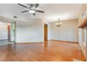 Bright living room with hardwood floors, a ceiling fan, and lots of natural light at 2201 Coach House Blvd # 3, Orlando, FL 32812