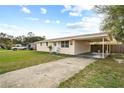 A cozy home featuring a convenient carport and a spacious driveway for easy parking at 2260 Danforth Ave, Deltona, FL 32738