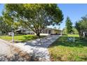 Charming home featuring well-kept lawn, carport and large tree providing shade at 2706 Cranmoor Dr, Kissimmee, FL 34758