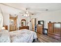 Well-lit primary bedroom showcasing natural light, ceiling fan, and ensuite access at 2706 Cranmoor Dr, Kissimmee, FL 34758