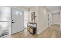 Well-lit foyer with decorative glass front door, stylish console table, and sleek laminate wood flooring at 277 Sandpiper Dr, Casselberry, FL 32707