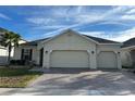 Charming single-story home featuring a three-car garage, well-manicured lawn, and a beautifully paved driveway at 3942 Green Sabal Dr, Orlando, FL 32824