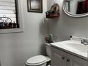 This half bath features modern fixtures, a vanity with storage, and a window for natural light at 4407 Lake Lawne Ave, Orlando, FL 32808