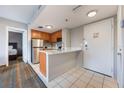 This is a kitchenette featuring stainless steel appliances and counter seating at 6165 Carrier Dr # 1504, Orlando, FL 32819