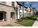 Charming townhome exteriors featuring brick walkways, lush landscaping, and well-manicured lawns at 8912 Adriatico Ln, Kissimmee, FL 34747