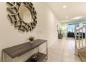 Bright hallway featuring modern decor and tiled floors, leading to the living area at 8912 Adriatico Ln, Kissimmee, FL 34747