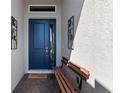 A stylish blue front door is accented by unique metal flower decorations and a charming welcome mat at 1121 Avery Meadows Way, Deland, FL 32724