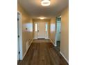 Welcoming foyer featuring a stylish front door, wood-look floors, and neutral paint colors at 117 Stewart Lake Loop, Groveland, FL 34736