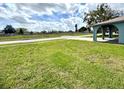Green front lawn and covered entry with arched supports on a corner lot in a quiet neighborhood at 1207 Rich Moor Cir, Orlando, FL 32807
