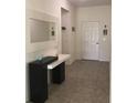 Bright foyer with tile flooring and a decorative console table with a mirror at 12126 Homestead Park Ln, Orlando, FL 32824