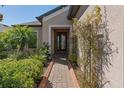 Inviting front entrance with a brick walkway and lush landscaping creating a warm welcome at 1392 Zeek Ridge St, Clermont, FL 34715