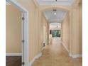 Bright hallway with tile flooring and elegant archways leading to different areas of the home at 1392 Zeek Ridge St, Clermont, FL 34715