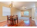 Traditional dining room features a wooden table set and wood flooring at 1401 Royal Saint George Dr, Orlando, FL 32828