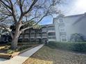 Attractive condo exterior featuring multiple balconies, mature trees, and well-kept landscaping at 14025 Fairway Island Dr # S, Orlando, FL 32837