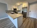 Updated kitchen with modern stainless-steel appliances, white cabinetry and stylish countertops at 14025 Fairway Island Dr # S, Orlando, FL 32837