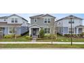 Charming two-story home with a manicured lawn and inviting front porch at 14146 Lanikai Beach Dr, Orlando, FL 32827
