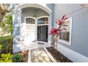 An inviting front entrance with sidelights and an overhanging arched porch at 14415 Estrella Dr, Orlando, FL 32837