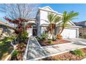 Inviting front walkway with landscaping leading to the front door of this charming two-story home at 14415 Estrella Dr, Orlando, FL 32837