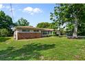 Attractive single-story home with a brick accent wall and a large, well-maintained lawn at 1508 Avenue H Ne, Winter Haven, FL 33881