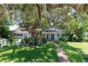 Beautiful single-story home with lush landscaping, a brick walkway, and a tree swing at 1721 Cheyenne Trl, Maitland, FL 32751