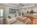 The light filled living room with an open-concept design provides seamless access to the outdoor pool and kitchen at 1731 Windsor Dr, Winter Park, FL 32789