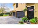 Charming home entrance with a two-car garage, well-lit entryway, and decorative plants at 184 Villa Di Este Ter # 200, Lake Mary, FL 32746