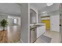 Modern kitchen featuring stainless steel appliances, granite countertops, and bright yellow accent wall at 193 Longview Ave # 104, Kissimmee, FL 34747