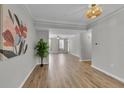 Spacious living room featuring hardwood floors and neutral gray walls at 193 Longview Ave # 104, Kissimmee, FL 34747