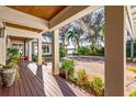 Inviting covered porch with wood floors, landscaping, and views of the property at 2118 Lake Dr, Winter Park, FL 32789