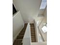 Bright entryway featuring hardwood stairs, with modern white accents and plenty of natural light at 2244 Shadowland Loop, Winter Park, FL 32792