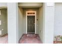 Close-up of the inviting front door with brick pavers and clean entryway, offering a warm welcome at 2412 Caravelle Cir, Kissimmee, FL 34746