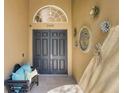 Charming front entrance featuring double doors, decorative accents, and a cozy bench at 2442 Heritage Green Ave, Davenport, FL 33837