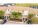 Nice townhomes with tile roofs, covered entries, landscaped grounds, and convenient parking at 3185 Pequod Pl, Kissimmee, FL 34746